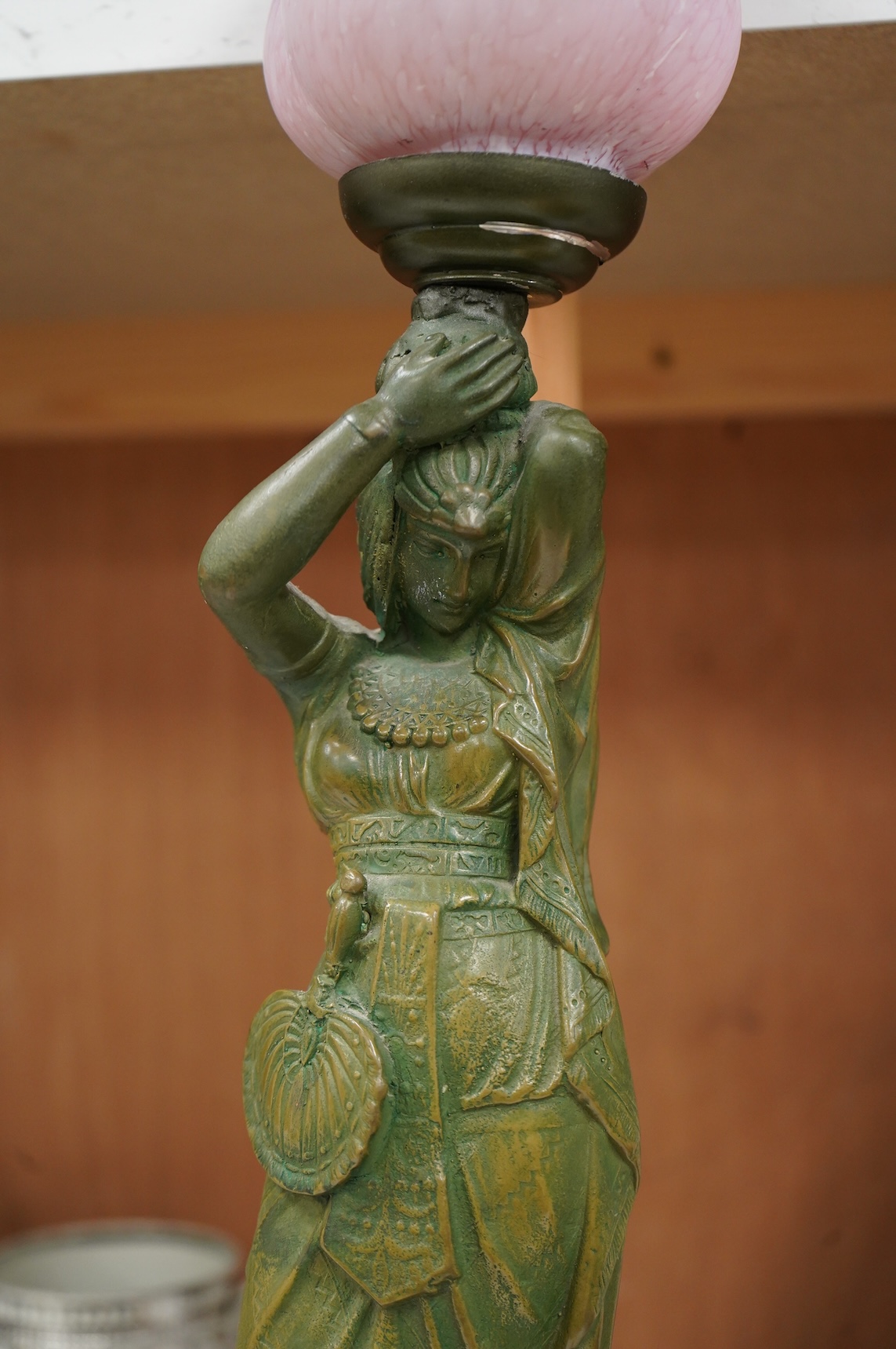 A composite lamp in the form of a female figure, with pink fluted glass shade, 50cm high overall